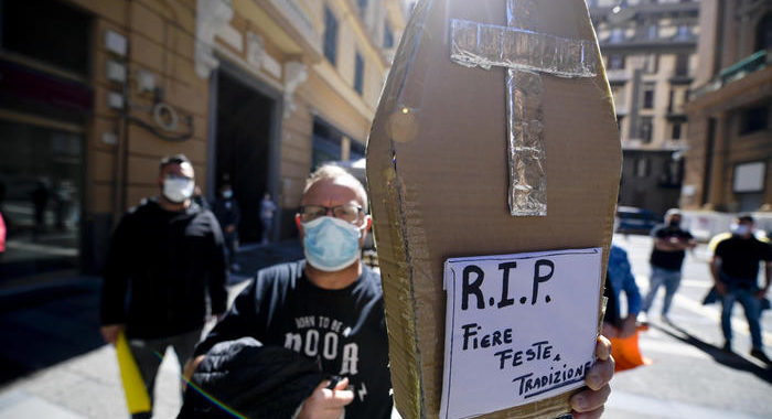 Ambulanti in piazza con bara di cartone