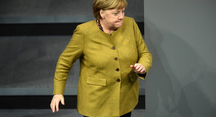 Merkel dimentica la mascherina e corre a riprenderla